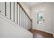 Bright entryway with hardwood floors and staircase with iron railing at 80 Hampton Ter, Dallas, GA 30157