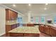 Large kitchen island with granite countertops and ample cabinet space at 6788 Oconee Pl, Fairburn, GA 30213