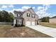 Two-story brick house with three-car garage and driveway at 6788 Oconee Pl, Fairburn, GA 30213