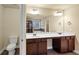 Bathroom with double vanity, toilet, and view into shower and tub at 6788 Oconee Pl, Fairburn, GA 30213