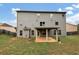 Gray house exterior with backyard and patio at 6788 Oconee Pl, Fairburn, GA 30213