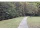 Curving sidewalk through grassy area with trees at 832 Arbor Gate Ln # 832, Lawrenceville, GA 30044