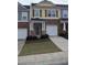 Two-story townhouse with two-car garage and stone accents at 832 Arbor Gate Ln # 832, Lawrenceville, GA 30044