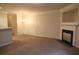 Spacious living room with neutral carpeting and a fireplace at 832 Arbor Gate Ln # 832, Lawrenceville, GA 30044