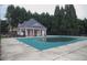 Community pool with brick bathhouse and pool cover at 832 Arbor Gate Ln # 832, Lawrenceville, GA 30044