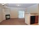 Open living room with a fireplace, kitchen bar, and access to a patio at 832 Arbor Gate Ln # 832, Lawrenceville, GA 30044