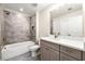 Bathroom with a shower/tub combo and gray tile at 2640 Joseph Dr, Cumming, GA 30028