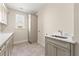 Bright laundry room featuring a utility sink and lots of storage at 2640 Joseph Dr, Cumming, GA 30028
