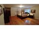 Spacious bedroom with hardwood floors and a large four-poster bed at 2565 Binghamton Dr, Atlanta, GA 30360