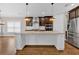 Large kitchen island with granite countertop and seating space at 11075 Ellsworth Cv, Suwanee, GA 30024