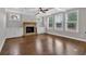 Gathering room featuring hardwood floors, fireplace and coffered ceiling at 11075 Ellsworth Cv, Suwanee, GA 30024