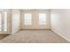 Living room with neutral carpeting and ample natural light at 6257 Selborn Sw Dr, Atlanta, GA 30331