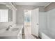 Updated bathroom with white vanity, quartz countertop and bathtub at 2645 Sims Crest Ct, Snellville, GA 30078