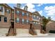 Brick front exterior of a charming townhome with a two-car garage and lush landscaping at 3135 Boldmere Se Trl, Smyrna, GA 30080