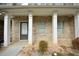 Front entrance of the home with white columns and a dark door at 1560 Iris Walk, Jonesboro, GA 30238