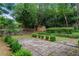 Landscaped backyard with patio, storage shed and lush greenery at 235 The Prado, Atlanta, GA 30309