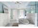 Luxurious bathroom with marble finishes, soaking tub, and glass shower at 235 The Prado, Atlanta, GA 30309