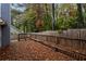 Wooden deck and fenced backyard with mature trees at 949 Heartwood Cir, Lawrenceville, GA 30043