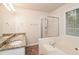 Double vanity bathroom with granite countertop, soaking tub, and shower at 949 Heartwood Cir, Lawrenceville, GA 30043