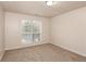 Well-lit bedroom with neutral wall paint and carpet at 949 Heartwood Cir, Lawrenceville, GA 30043