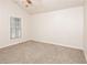 Spacious bedroom with neutral walls and carpet, featuring a large window at 949 Heartwood Cir, Lawrenceville, GA 30043