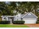 Gray two-story house with a white two-car garage and manicured lawn at 949 Heartwood Cir, Lawrenceville, GA 30043