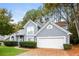 Two-story house with gray siding, a white garage door, and landscaping at 949 Heartwood Cir, Lawrenceville, GA 30043