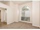 Bright living room featuring a large arched window and neutral carpeting at 949 Heartwood Cir, Lawrenceville, GA 30043