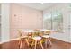 Elegant dining area with a blush-colored accent wall and modern table at 4429 Newfangle Rd, Stone Mountain, GA 30083