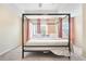 Main bedroom with a canopy bed, carpet flooring and two windows at 4429 Newfangle Rd, Stone Mountain, GA 30083