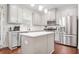 Modern kitchen with gray cabinets, stainless steel appliances, and an island at 4429 Newfangle Rd, Stone Mountain, GA 30083