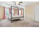 Main bedroom with a canopy bed, carpet flooring and two windows at 4429 Newfangle Rd, Stone Mountain, GA 30083