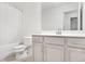 Main bathroom with shower/tub combo and grey vanity at 4429 Newfangle Rd, Stone Mountain, GA 30083
