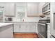 Modern kitchen with gray cabinets, stainless steel appliances, and an island at 4429 Newfangle Rd, Stone Mountain, GA 30083