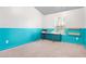 Bright bedroom with teal accent wall and built-in shelving at 4429 Newfangle Rd, Stone Mountain, GA 30083