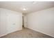 Well-lit bedroom with neutral walls, carpet, and double doors to closet at 4112 Meadowlark Ct, Powder Springs, GA 30127