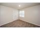 Spacious bedroom with neutral walls and carpet, and a window at 4112 Meadowlark Ct, Powder Springs, GA 30127