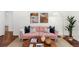 Pink sofa and wooden coffee table in bright living room at 2091 East Dr, Decatur, GA 30032