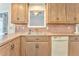 Kitchen boasts wood cabinets, double sink, and dishwasher at 408 Gray Fox Dr, Canton, GA 30114