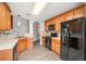 Kitchen with wood cabinets, black appliances, and light countertops at 259 Diamond Valley Pass, Canton, GA 30114