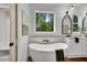 Relaxing bathroom featuring a freestanding tub and large window at 3549 Cheatham Nw Rd, Acworth, GA 30101