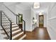 Modern staircase with metal railing and hardwood steps at 3549 Cheatham Nw Rd, Acworth, GA 30101