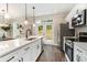 Modern kitchen with white cabinets, stainless steel appliances, and quartz countertops at 1525 Burberry Alley, Marietta, GA 30008