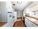 Long kitchen with white cabinets and wood countertops at 6332 N Hampton Dr, Atlanta, GA 30328