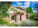 Brick home with covered porch and mature trees at 250 Big Oak Rd, Whitesburg, GA 30185
