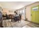 Bright dining area features a wooden table with four chairs and wood-look flooring at 2376 Falls River Dr, Lithia Springs, GA 30122