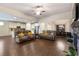 Open concept living room with a stone fireplace, hardwood floors, and views into the kitchen at 90 Hickory Pointe Dr, Acworth, GA 30101