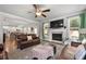 Spacious living room with fireplace, hardwood floors, and leather furniture at 197 Stafford Ln, Villa Rica, GA 30180
