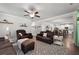 Open living room with hardwood floors, leather furniture, and view of the kitchen at 197 Stafford Ln, Villa Rica, GA 30180