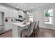 Bright kitchen with white cabinets, center island, and hardwood floors at 197 Stafford Ln, Villa Rica, GA 30180